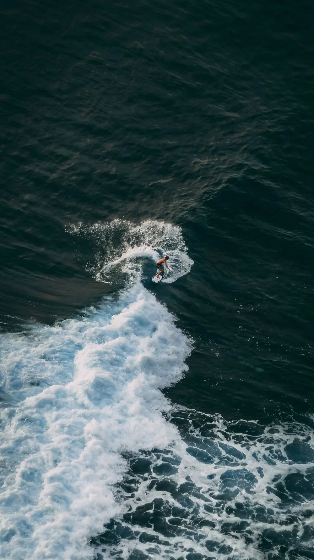 A surfer redirecting through a cutback